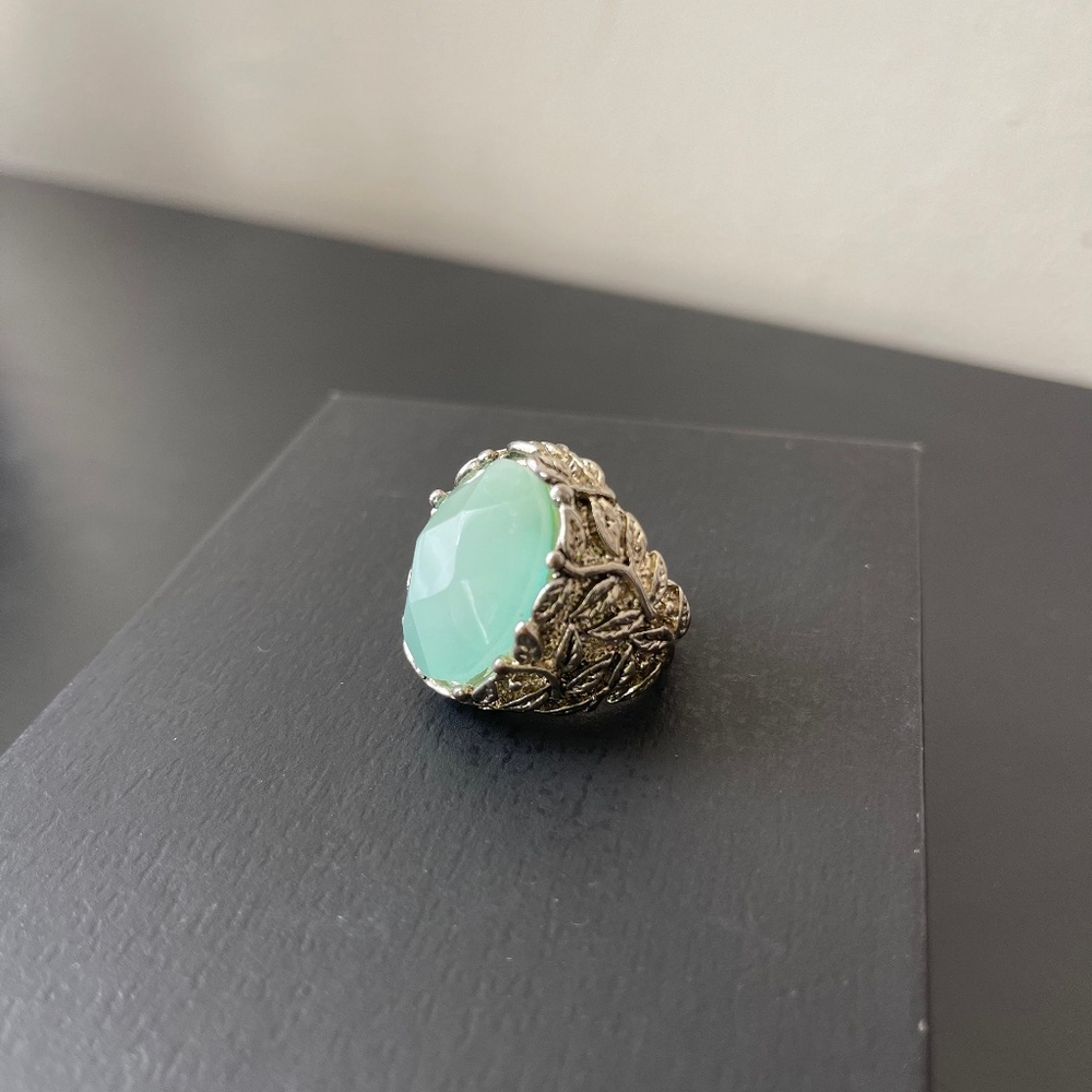 Ring with light blue stone